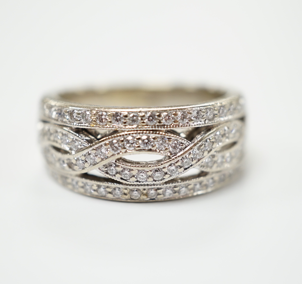 A modern 14ct gold and diamond chip set spiral band cluster half hoop ring, size L, gross weight 7.3 grams.